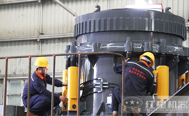 工作人員檢測圓錐破碎機(jī)，保障生產(chǎn)的設(shè)備都有高質(zhì)量